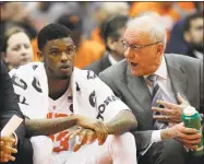  ?? Nick Lisi / Associated Press ?? Syracuse head coach Jim Boeheim talks with Frank Howard on the bench against Louisville on Wednesday.