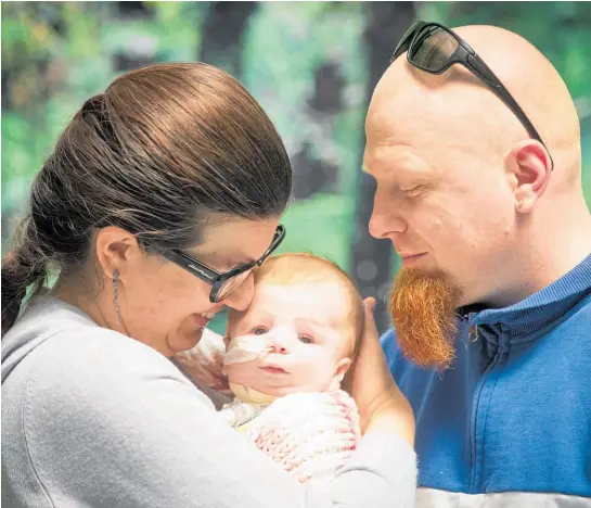  ?? Photo / Jason Oxenham ?? Yulia and Konstantin Emanov hold 3-month-old daughter Eva, who was born with a rare genetic disease called Pierre Robin sequence which means she cannot breathe by herself.