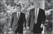  ?? AP/EVAN VUCCI ?? President Donald Trump walks Friday with South Korean President Moon Jae-in to make statements in the Rose Garden at the White House in Washington.