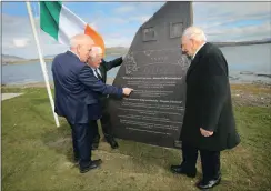  ??  ?? (Right) Former Minister Jimmy Deenihan inspects the monument in Valentia with Tim Ring’s son Diarmuid and Eugene Ring’s son Austin.
