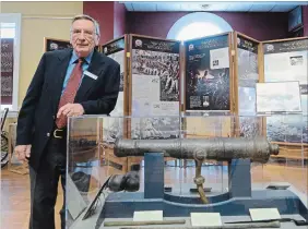  ?? DAVE JOHNSON THE WELLAND TRIBUNE ?? Marine archeologi­st Ken Cassavoy leans on a display holding at canon at Welland Museum on Saturday. Cassavoy was at the museum for the opening exhibit on HMS General Hunter, a vessel he excavated in the early 2000s.