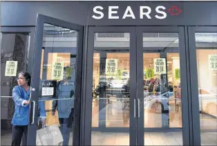  ?? CP PHOTO ?? Shoppers enter and leave a Sears retail store in Toronto on Oct. 19, 2017.