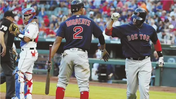  ?? AP PHOTO ?? HOT IN TEXAS: J.D. Martinez celebrates with Xander Bogaerts after homering in the Red Sox’ 5-1 victory against the Texas Rangers last night in Arlington, Texas.