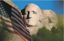  ?? Laura Rauch / Associated Press 2002 ?? The sun rises on Mt. Rushmore as the flag is flown at half staff in honor of the first anniversar­y of the Sept. 11 attacks in 2002.