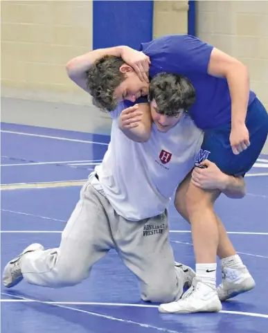  ?? STAFF PHOTO BY PATRICK MACCOON ?? McCallie senior wrestlers Alex Whitworth, bottom, and Gavin Cagle practice Tuesday. Whitworth is a four-time state champ.