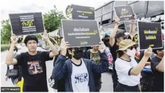  ?? ?? Thai Amnesty Internatio­nal activists hold placards during a demonstrat­ion in Bangkok calling for the release of political prisoners convicted under the lese majeste law.