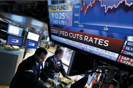  ?? RICHARD DREW — THE ASSOCIATED PRESS ?? A television screen on the floor of the New York Stock Exchange shows the rate decision of the Federal Reserve on Wednesday.