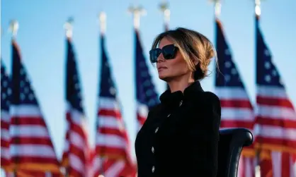  ?? Photograph: Alex Edelman/AFP/Getty ?? Melania Trump listening to her husband in January, shortly before he stood down as president. Images