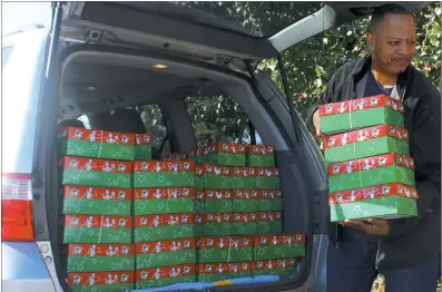  ??  ?? Darryl Evans helps load 176 Operation Christmas Child boxes into Ken Weikel’s truck last week. Evans and his wife Ernestine donated half the boxes and collected the other half through their church, Victory Chapel in Accokeek. Weikel and his wife...