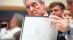  ?? ALEX BRANDON/AP ?? Robert Mueller checks pages in his report on Russian election interferen­ce as he testifies before the House Judiciary Committee Wednesday.