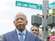  ?? AP PHOTO BY BRINLEY HINEMAN ?? U.S. Rep. John Lewis stands in front of John Lewis Freedom Parkway Wednesday moments after the street name was unveiled in Atlanta.