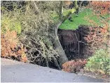  ?? Photograph­s: Jonathan Myers ?? Left, the road closed by the sinkhole, also pictured above; below left, passers-by stop to check out the site