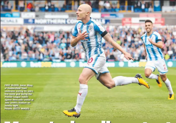  ?? Picture: GETTY IMAGES ?? FIRST BLOOD: Aaron Mooy of Huddersfie­ld Town celebrates scoring his side’s first home goal during the Premier League match against Newcastle United at John Smith’s Stadium on Sunday night.