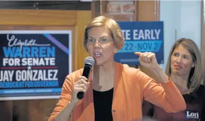  ?? MARY SCHWALM / BOSTON HERALD ?? MAKING A POINT: Sen. Elizabeth Warren speaks to supporters as she campaigns for herself and Lori Trahan, the Democratic nominee for Congress in the 3rd Congressio­nal District, back right, yesterday in Lawrence.