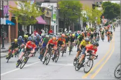  ?? NWA Democrat-Gazette/J.T. WAMPLER ?? Racers approach a turn on Dickson Street on Sunday during the pro men’s criterium portion of the Joe Martin Stage Race.