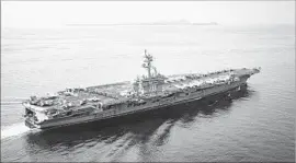  ?? Sean M. Castellano U.S. Navy ?? THE AIRCRAFT carrier Carl Vinson sails through the Sunda Strait in Indonesia last week, raising fresh questions about the credibilit­y of the White House.