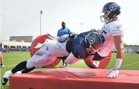  ??  ?? Titans linebacker Will Compton (51) tackles tight end Ethan Wolf (45) during tackling drills on Monday. GEORGE WALKER IV / TENNESSEAN.COM