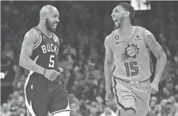  ?? MICHAEL CHOW/THE REPUBLIC ?? Milwaukee Bucks guard Jevon Carter (5) talks with Phoenix Suns guard Cameron Payne (15) after Carter hit a 3-point basket during the fourth quarter Tuesday at Footprint Center.