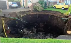  ??  ?? Sinkhole: The crater that opened up in a suburban street