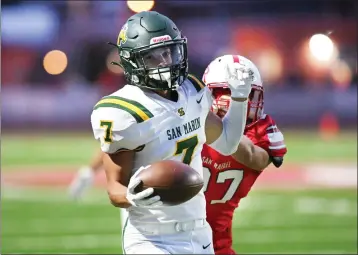  ?? PHOTOS BY SHERRY LAVARS — MARIN INDEPENDEN­T JOURNAL ?? San Marin's Blake Hart (7) returns a San Rafael punt for a touchdown during Friday's MCAL game in San Rafael.