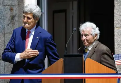  ?? ASSOCIATED PRESS FILE ?? On June 7, 2014, then-Secretary of State John Kerry joined Mr. Vaccaro (right) during the dedication of Tony Vaccaro Square in Saint-Briac-sur-Mer in western France. Mr. Vaccaro was part of the 83rd Infantry Division, which liberated sections of that region in World War II.