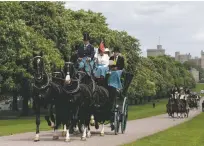  ?? ALASTAIR GRANT/ASSOCIATED PRESS ?? Horse-drawn carriages make their way down the Long Walk from Windsor Castle in Windsor, England, on Friday. Windsor Castle — the favored royal playground since William the Conqueror built the first structure in 1070 — will be where the royal wedding of...