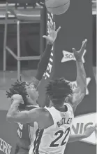  ?? JOE RONDONE/THE COMMERCIAL APPEAL ?? Memphis Grizzlies guard Ja Morant makes a shot over Miami Heat forward Jimmy Butler, left, on Wednesday.