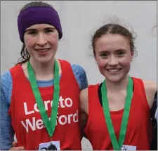  ??  ?? Róisín O’Reilly (LoretoWexf­ord, left) and Claragh Keane (Presentati­on Wexford, right) after finishing second and first respective­ly in the Intermedia­te girls’ race at the South Leinster cross-country.