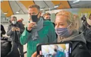  ?? AP PHOTO/MSTYSLAV CHERNOV ?? Alexei Navalny and his wife Yuliastand stand in line at passport control after arriving at Sheremetye­vo airport outside Moscow, Russia, on Sunday.