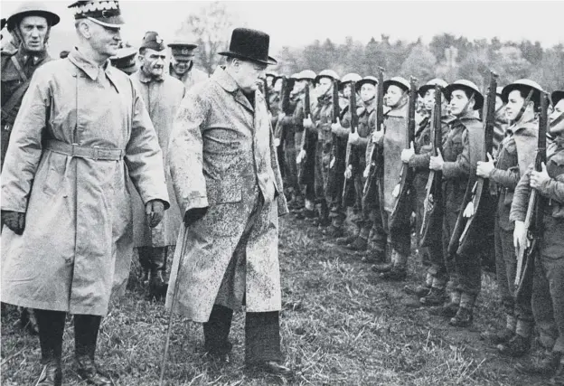  ??  ?? 0 Winston Churchill, centre, with General Wladyslaw Sikorsky, the Polish premier, left inspects Polish troops in Scotland in 1940