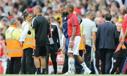  ?? Photograph: Michael Zemanek/BPI/Rex/ Shuttersto­ck ?? Arsenal’s Alexandre Lacazette wears a protective boot after being injured in the defeat by Lyon.