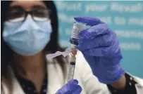  ?? CLIFFORD SKARSTEDT EXAMINER ?? Pharmacist Batool Fatima prepares an AstraZenec­a vaccine dose at Rexall Pharmacy at Portage Place on Wednesday.