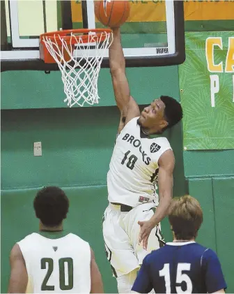  ?? STAFF PHOTO BY NICOLAUS CZARNECKI ?? JAM SESSION: Brooks’ Jacob Iwowo throws down a dunk during yesterday’s 60-57 victory against Beaver Country Day in the BABC Prep Classic at Cathedral High.