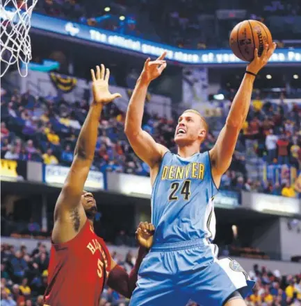  ??  ?? Denver Nuggets center Mason Plumlee shoots over Indiana Pacers center Lavoy Allen during Friday night’s game in Indianapol­is. The Nuggets won 125-117, improving their record to 35-37. R Brent Smith, The Associate Press