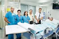  ?? (Piotr Flitr) ?? PROF. GIL BOLOTIN (far right) and colleagues are seen with crush victim Mohammed Jabari, connected to the ECMO machine at Haifa’s Rambam Medical Center.