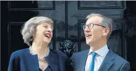  ?? Justin Tallis AFP/Getty Images ?? THERESA MAY, left, Britain’s new prime minister, and her husband, Philip John May, share a laugh outside the official residence at 10 Downing St. in London.