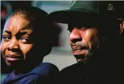  ?? MATT ROURKE/AP ?? Wayne Jones, holding his son Donell, speaks about his mother Celestine Chaney. She was one of 10 Black people killed in a mass shooting Saturday at a supermarke­t in Buffalo, N.Y. She had gone there looking to buy shortcakes.