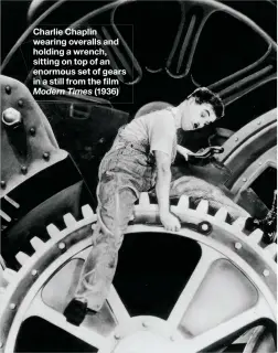 ??  ?? Charlie Chaplin wearing overalls and holding a wrench, sitting on top of an enormous set of gears in a still from the film Modern Times (1936)