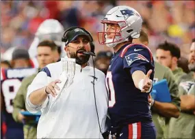  ?? Matt Stone / TNS ?? Patriots assistant coach Matt Patricia talks with Mac Jones during Sunday’s win over the Colts.