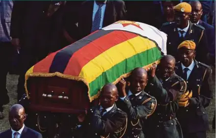  ?? REUTERS PIC ?? Military personnel carrying the casket of former Zimbabwean president Robert Mugabe at the Rufaro stadium in Harare on Friday.