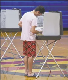  ?? H John Voorhees III / Hearst Connecticu­t Media ?? Ethan Escobar, of Danbury, votes in the state primary on Aug. 14. Voters in the 5th Ward voted in the War Memorial building in Danbury. About 32 percent of registered Republican­s and 29 percent of registered Democrats voted in the primary, according to the latest but unofficial results from the Secretary of the State’s office.At left, Dan Dernbach, of Danbury, votes.