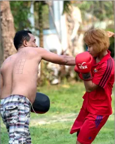  ??  ?? Myanmar female Lethwei fighter Lin Yone May (right) trains with her coach at a Buddhist monastery compound ahead of a Lethwei competitio­n in the town of Maungdaw in Rakhine state. — AFP photos