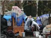 ?? JOSH EDELSON — AFP VIA GETTY IMAGES ?? A man who only goes by the name David gulps a drink at a San Jose homeless encampment known as “The Jungle” in 2014. Data shows homelessne­ss has increased by double digits across the region.