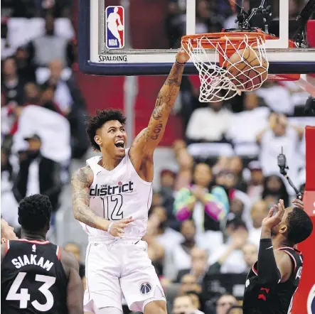 ?? PHOTOS: NICK WASS/THE ASSOCIATED PRESS ?? Forward Kelly Oubre Jr. dunks as the Washington Wizards earned their first win of the series Friday on home court, downing the Toronto Raptors 122-103 in Game 3.