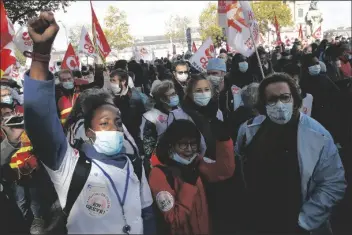  ?? ASSOCIATED PRESS ?? MEDICAL WORKERS DEMONSTRAT­E TO DEMAND better salaries and working conditions Thursday in Paris. French President Emmanuel Macron has announced that millions of French citizens in several regions around the country, including in Paris, will have to respect a 9 p.m. curfew from this Saturday until Dec. 1. It’s a new measure aimed at curbing the resurgent coronaviru­s amid second wave.