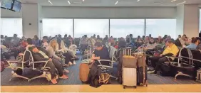  ??  ?? A waiting area is packed at New York City’s JFK airport Jan 4. GETTY IMAGES