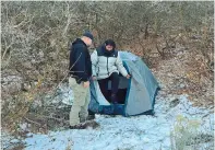  ?? ?? A policeman stands next to Kai Zhuang at the site where he was found in the Utah mountains. — Reuters