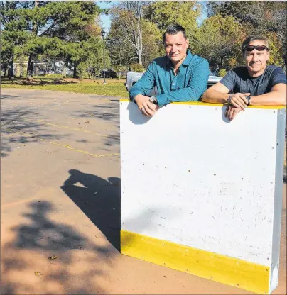  ?? COLIN MACLEAN/JOURNAL PIONEER ?? Summerside is putting some of its old hockey rink boards to good use by using them at a new ice pad it intends to install at Schurman Park. Displaying one of the boards is JP Desrosiers, left, director of community services, and Trent Williams,...