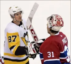  ?? Frank Gunn/The Canadian Press via Associated Press ?? Penguins center Sidney Crosby congratula­tes Canadiens goaltender Carey Price after Montreal defeated Pittsburgh, 2-0, to win the five-game qualifying series Friday in Toronto.
