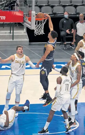  ?? Ronald Martinez, Getty Images ?? Denver’s Michael Porter Jr. makes a slam dunk against Dallas in the fourth quarter on Monday night. Porter lead the Nuggets with 30 points.